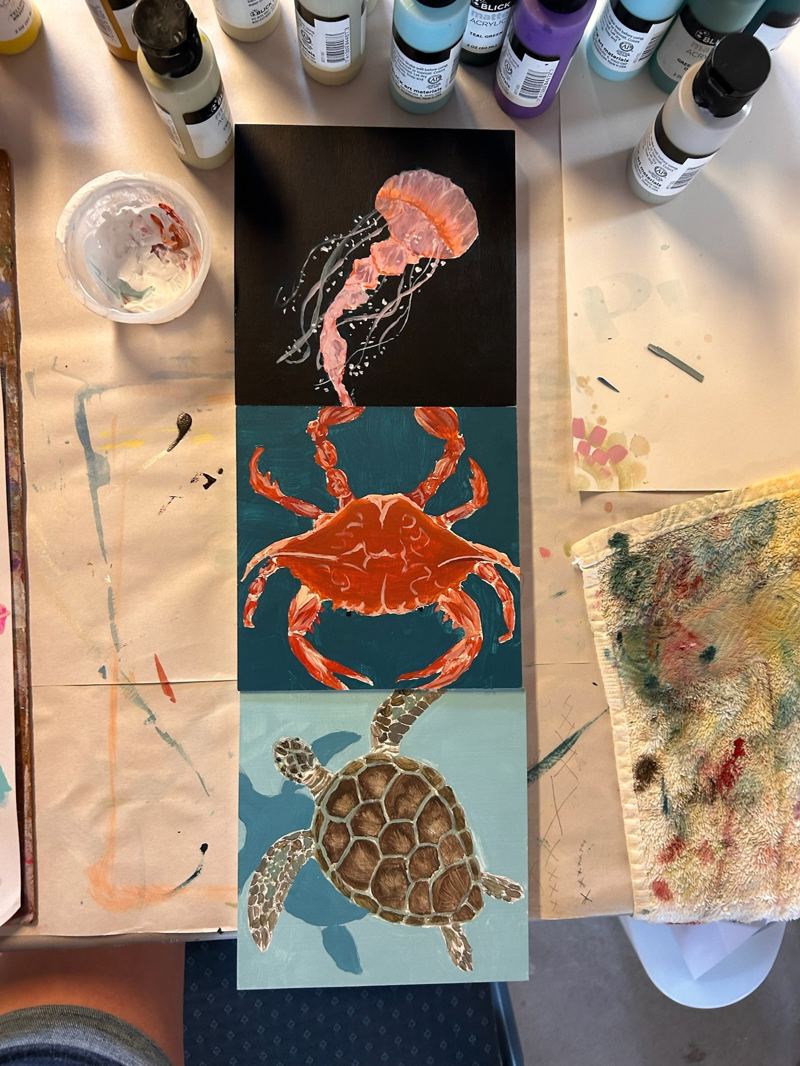 Painted panel of a jellyfish, crab, and sea turtle