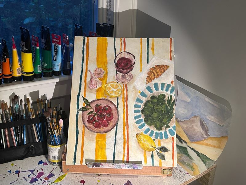 Still life painting of fruit, a croissant, and a plate
