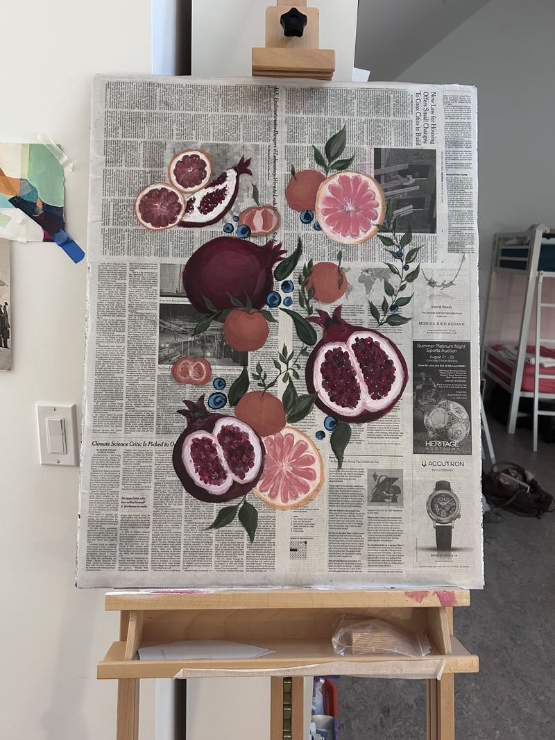 Still life painting of pomegranates, citrus, and blueberries on a newspaper-collage canvas