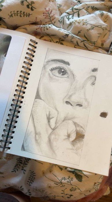 Pencil sketch detail of a face and hand