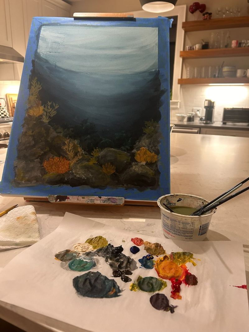 Ocean-themed painting in progress on an easel