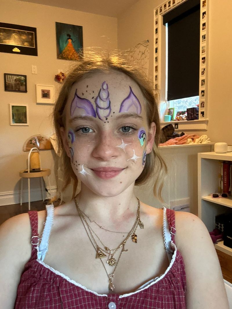 Unicorn face paint design on forehead