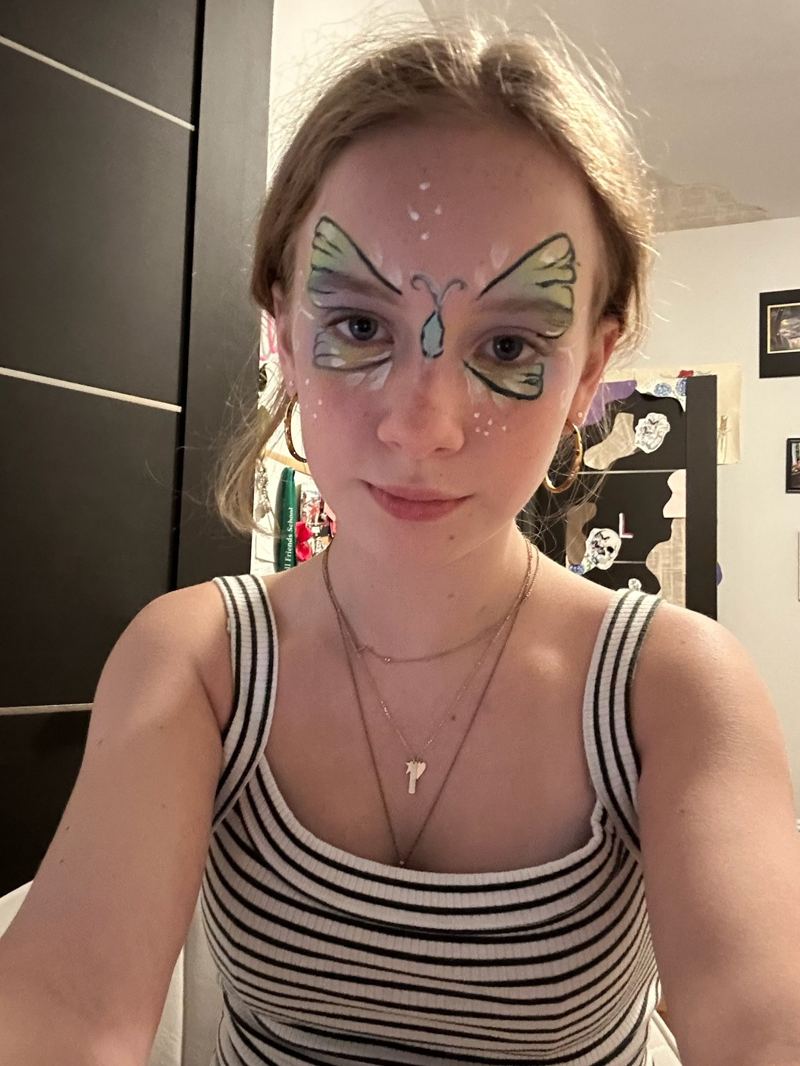 Teal and purple butterfly face paint design