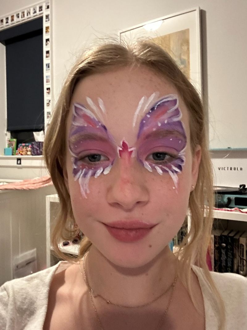 Pink and purple butterfly face paint design
