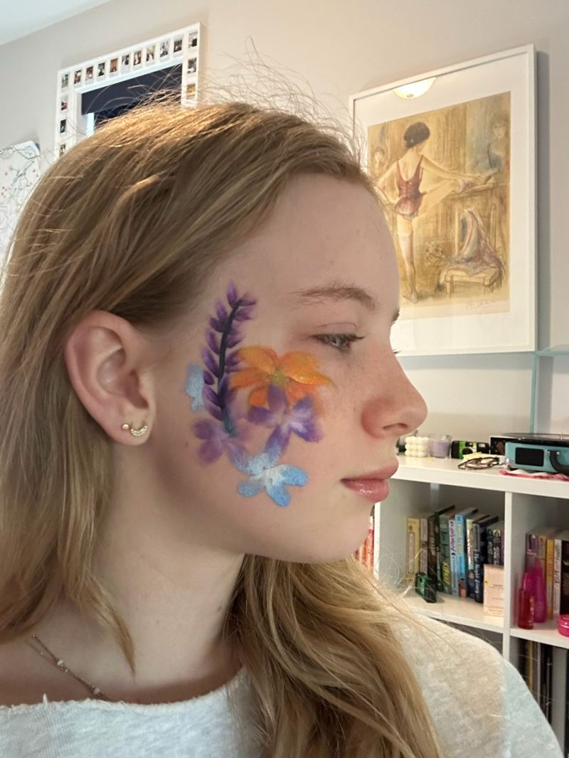 Floral accent face paint on the cheek