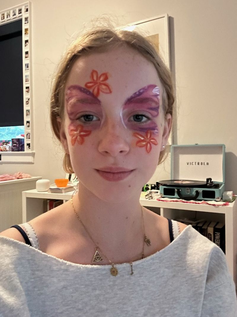 Delicate flower accents painted under the eyes