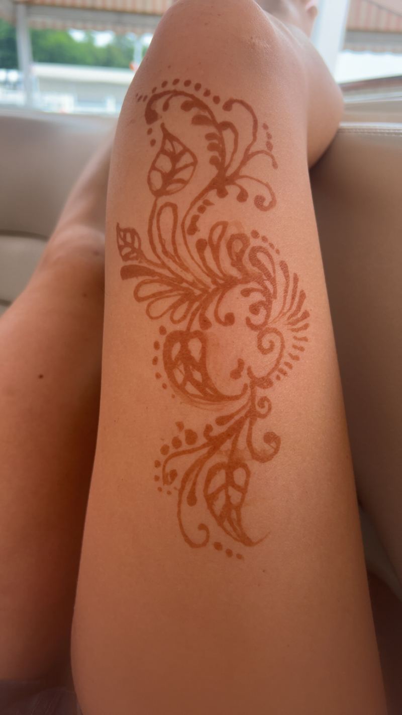 Paisley and floral henna design on the upper arm