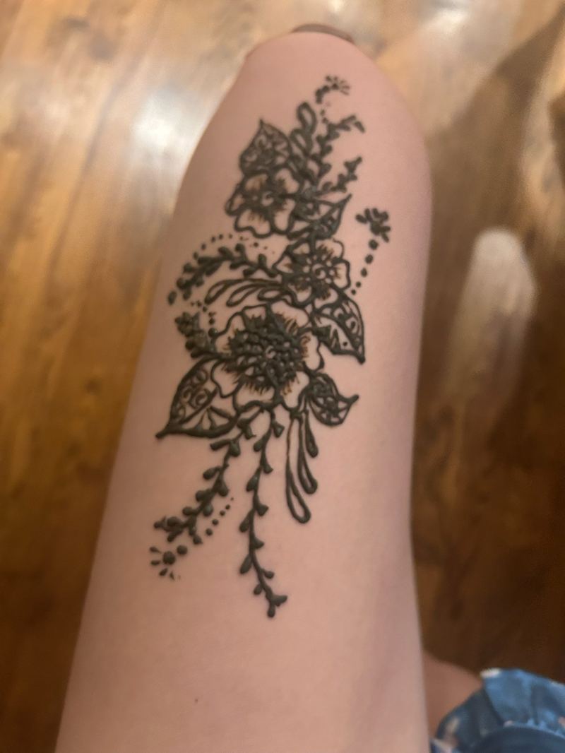 Floral henna design on the forearm