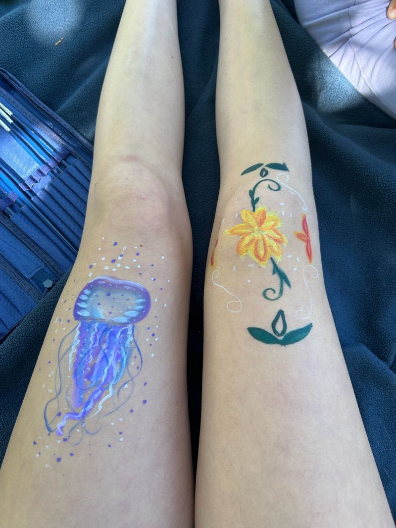 Colorful jellyfish and flower body paint on the legs