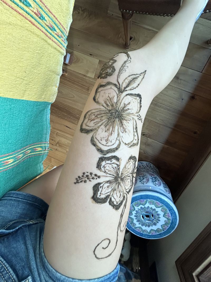 Hibiscus flower henna design on the upper arm