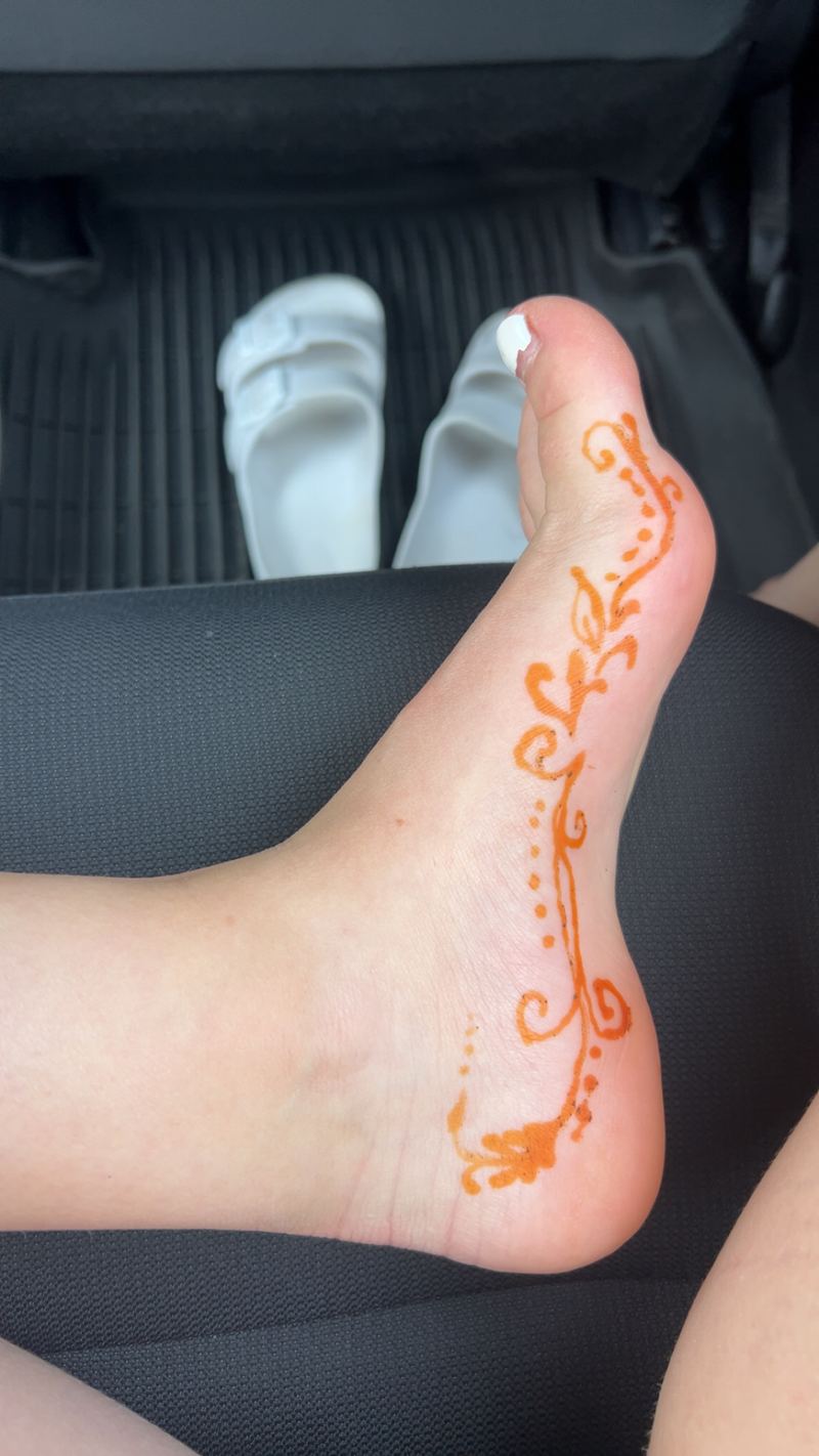 Henna vine design on the top of a foot